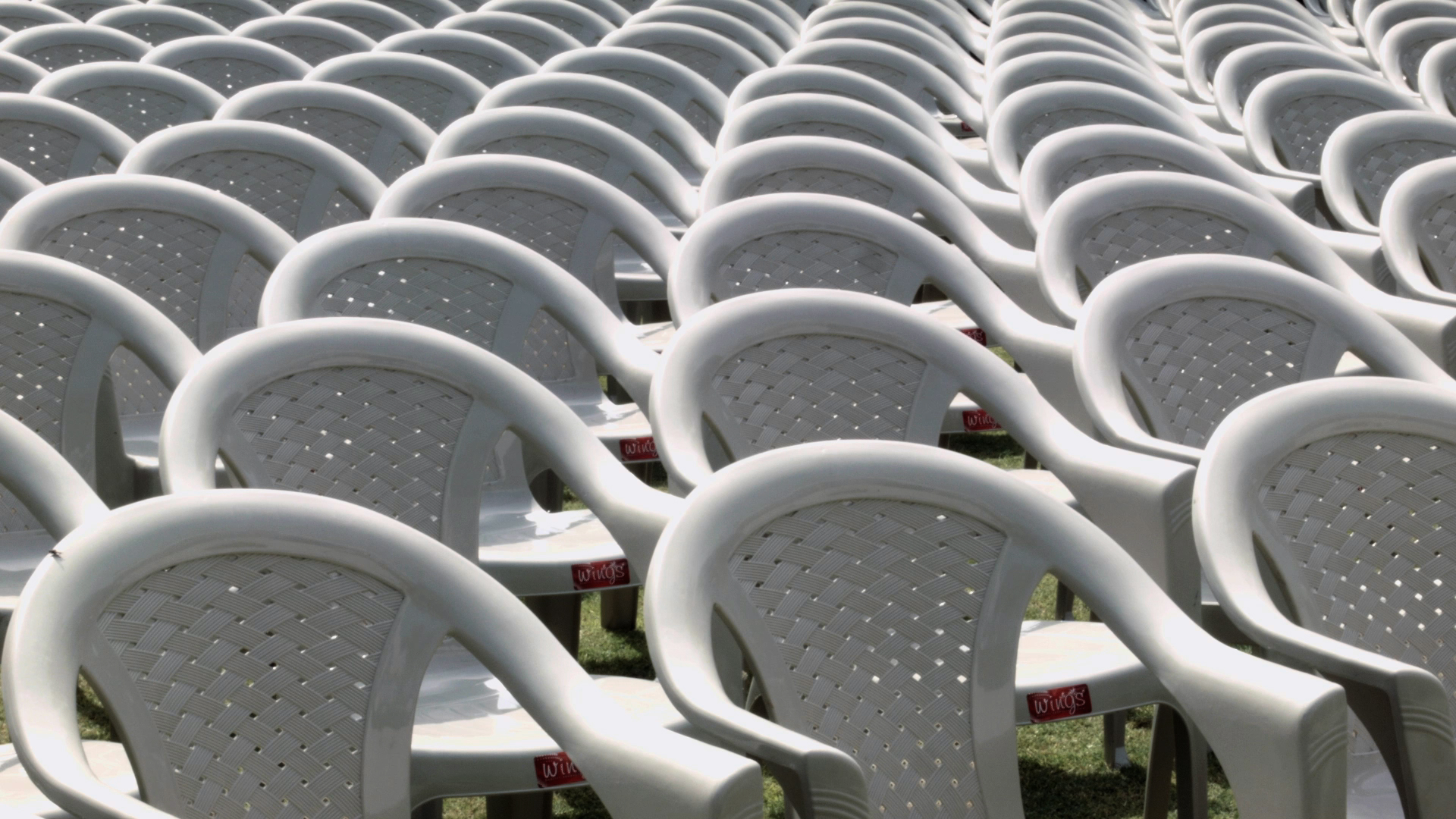 rows and rows of empty white plastic chairs