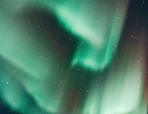 an image of the night sky lit by green streaks, which are the northern lights