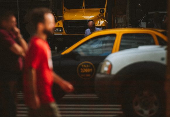 a blurry photograph of a buenos aires taxi at a busy intersection.